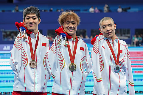 2024 Paris Paralympics: Yuan Weiyi, Guo Jincheng and Wang Linchao, of China, celebrate after Men's 50m Backstroke -S5